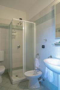 a bathroom with a shower and a toilet and a sink at HOTEL DEL CORSO in Borgomanero