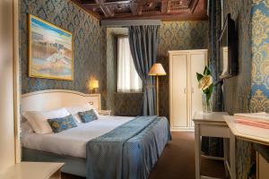 a bedroom with a bed in a room with blue wallpaper at Residenza Canova Tadolini - Guesthouse in Rome +52 photos