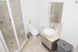 a bathroom with a toilet and a sink and a shower at CAG The Cube Rivonia in Johannesburg