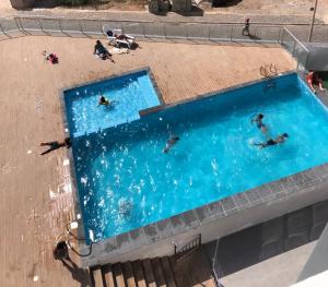 a group of people swimming in a swimming pool at Kasa Imbondeiro in Mindelo