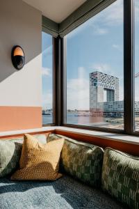 a living room with a couch and a window at Hotel BOAT & CO in Amsterdam