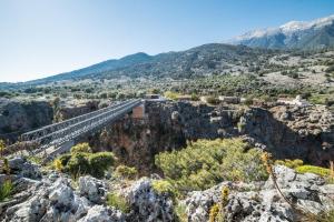 a bridge on the side of a mountain at ARADENA TRADITIONAL House 4 in Arádhaina
