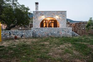 a stone house with a stone wall at ARADENA TRADITIONAL House 4 in Arádhaina