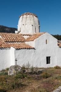 a church with a cross on the side of it at ARADENA TRADITIONAL House 4 in Arádhaina