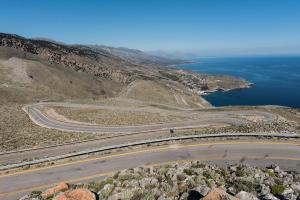 an aerial view of a road on a hill with the ocean at ARADENA TRADITIONAL House 4 in Arádhaina