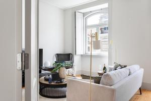 a living room with a white couch and a table at ALTIDO Downtown Bliss Apartments in Lisbon
