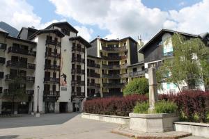 a large apartment building with a statue in front of it at Apartment Lognan 1 in Chamonix