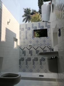 a bathroom with a toilet and a sink at Granados in Asuncion