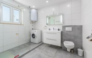 a white bathroom with a washing machine and a washer at Apartments Smilys in Novigrad Istria +23 photos