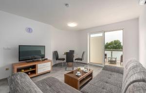 a living room with two couches and a television at Apartments Smilys in Novigrad Istria