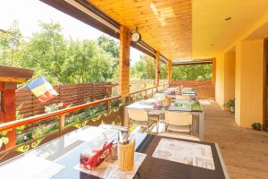 a restaurant with tables and chairs on a balcony at Rosiem House in Techirghiol