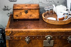 an old suitcase with a basket on top of it at Beachlands Hotel in Weston-super-Mare