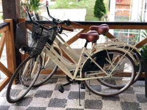 a white bike with a basket parked on a porch at Magnolia by Radovanovic in Ždrelo