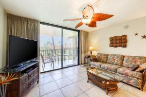 a living room with a couch and a flat screen tv at Kamaole Sands in Wailea