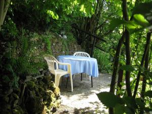 two chairs and a table with a blue table cloth at Ferienwohnung Salker in Daun