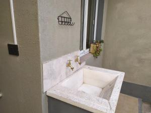 a white sink in front of a window at Casa en La Viña in San Salvador de Jujuy