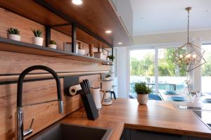 a kitchen with a wooden counter top and a sink at Strandvilla Gezeiten in Boltenhagen