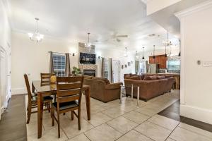 a dining room and living room with a table and chairs at Spacious 4BR City Condo steps from St Charles Ave in New Orleans