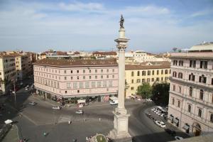 a large pole with a statue in the middle of a city at Biancorèroma B&B in Rome