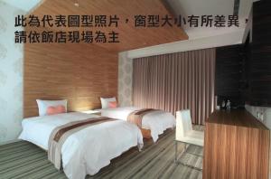 Ліжко або ліжка в номері Yoai Hotel