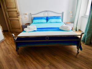 a bed with blue sheets and blue pillows in a room at LE GIÜE in Genoa