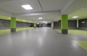 an empty hallway with green columns in a building at Strandvilla Gezeiten in Boltenhagen