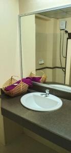 a bathroom counter with a sink and a mirror at Banyan Resort Bangsaen in Bangsaen