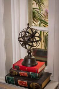 a globe on top of books on a window sill at Beachlands Hotel in Weston-super-Mare