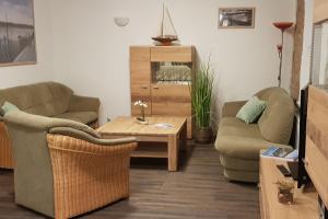a living room with two couches and a coffee table at Stolpseeblick in Himmelpfort