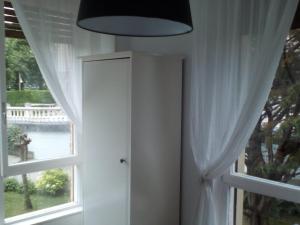 a room with a window with white curtains at Precioso, luminoso y cómodo in Castro-Urdiales