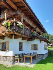 a house in the mountains with a wooden roof at Haus Wildschütz in Hippach