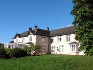 a large white house with a large yard at Riversdale Farm B&B in Ballinamore