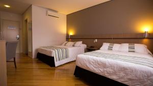 Cama ou camas em um quarto em Viale Cataratas Hotel & Eventos