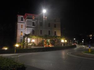 a building with a light on top of it at night at Hotel Giardinetto in Desenzano del Garda