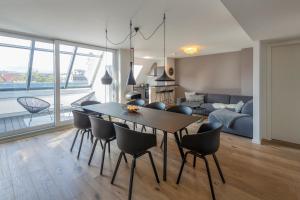 a dining room and living room with a table and chairs at cosy grey apartments in Freiburg im Breisgau