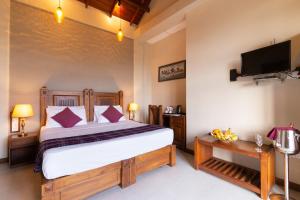 a bedroom with a bed and a flat screen tv at Piumara Residence in Kandy