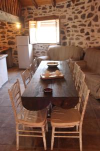 a wooden table and chairs in a living room at Alojamiento Los Chozos in Cazalla de la Sierra