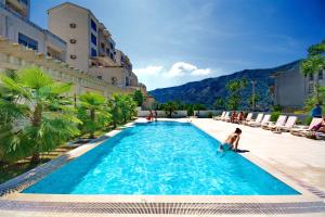 a child in a swimming pool at a hotel at Apartment Dobrota View in Dobrota