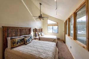 a bedroom with two beds and a ceiling fan at Red Pine Condominiums in Park City