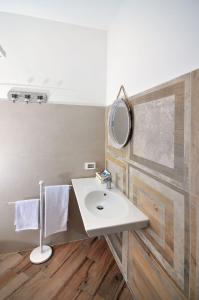 a bathroom with a white sink and a mirror at B&B Il Lentisco in Camerota