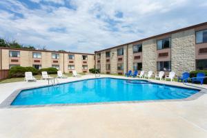 a swimming pool in front of a building at Days Inn by Wyndham Hillsborough in Hillsborough