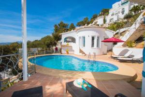 a villa with a swimming pool on a hill at Casa Infinidad in Moraira