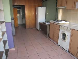 a kitchen with a refrigerator and a washing machine at FİLİZ PANSİYON in Denizli