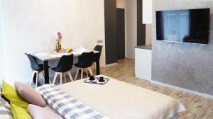 a living room with a table and a tv at Art Apartments II in Wrocław