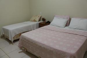 Een bed of bedden in een kamer bij Hotel Cambui