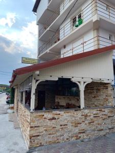 a building with a balcony on the side of it at Hotel Monte Carlo in Piteşti