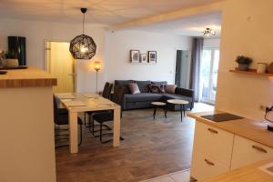 a kitchen and living room with a couch and a table at Wohnen am Solbad in Bad Salzungen