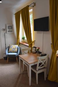 a living room with a table and a chair at Hostel Coco in Warsaw