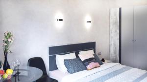 a bedroom with a bed and a glass table at Art Apartments II in Wrocław