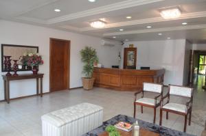 eine Lobby mit einem Wartezimmer mit Stühlen und einem Schreibtisch in der Unterkunft River Hotel in Uruguaiana